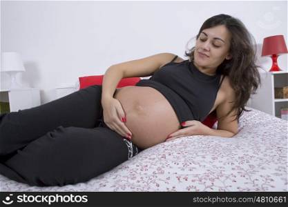 young pregnant woman in bed, focus on the face
