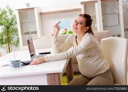 Young pregnant woman in budget planning concept