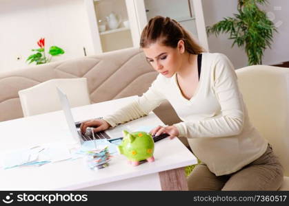 Young pregnant woman in budget planning concept 