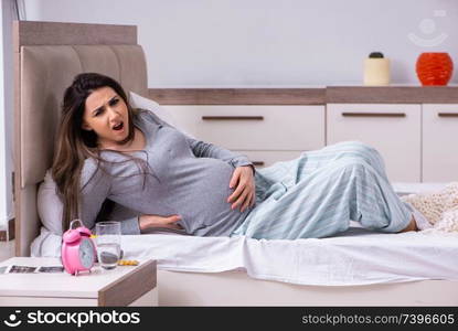 Young pregnant woman in the bedroom 