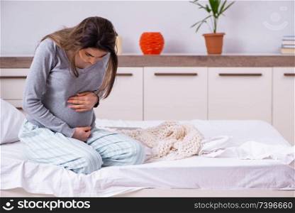Young pregnant woman in the bedroom 