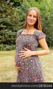 young pregnant woman in the park