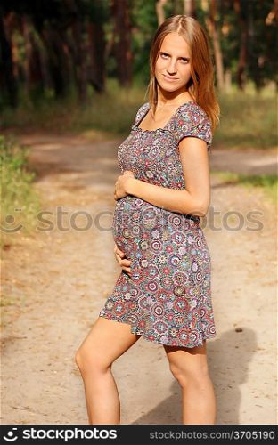 young pregnant woman in the park