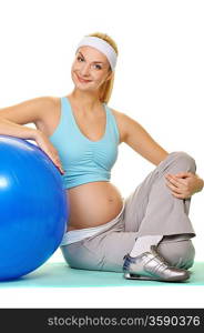 Young pregnant woman making exercise with a fitness ball