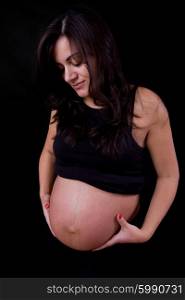 young pregnant woman, on a black background