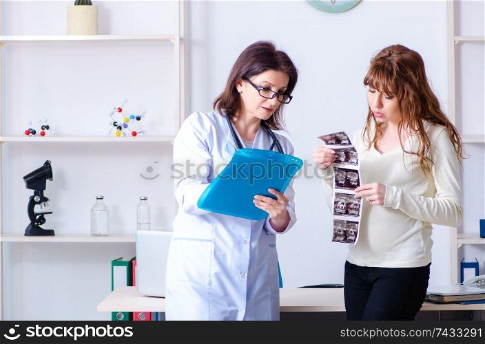 Young pregnant woman visiting experienced doctor gynecologist . Young pregnant woman visiting experienced doctor gynecologist