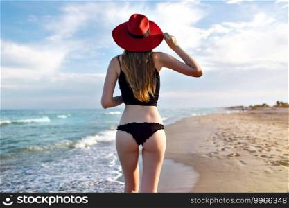 Young pretty blonde woman wearing black bikini