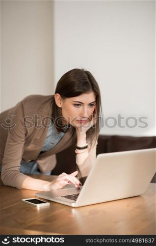 Young pretty business woman with laptop in the office