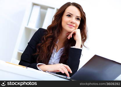 Young pretty business woman with notebook in the office