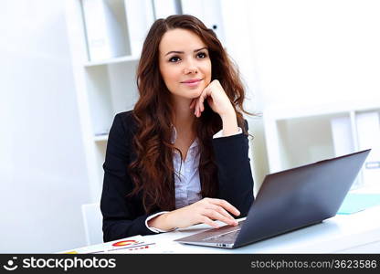 Young pretty business woman with notebook in the office