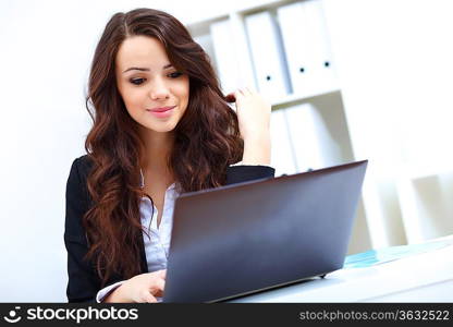 Young pretty business woman with notebook in the office