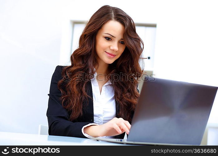 Young pretty business woman with notebook in the office