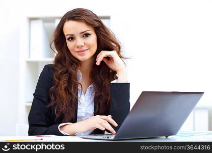 Young pretty business woman with notebook in the office