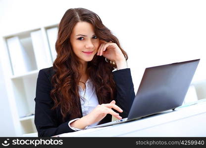 Young pretty business woman with notebook in the office