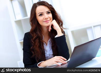 Young pretty business woman with notebook in the office