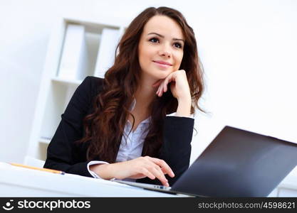 Young pretty business woman with notebook in the office