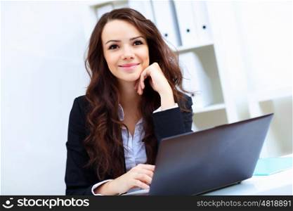 Young pretty business woman with notebook in the office