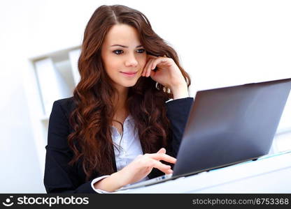 Young pretty business woman with notebook in the office