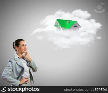 Young pretty businesswoman with houses over head. Thoughtful businesswoman
