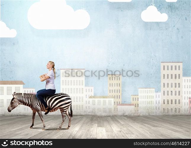 Young pretty fearless woman riding zebra animal. Woman ride zebra