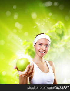 Young pretty girl in sport wear with green apple