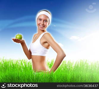 Young pretty girl in sport wear with green apple