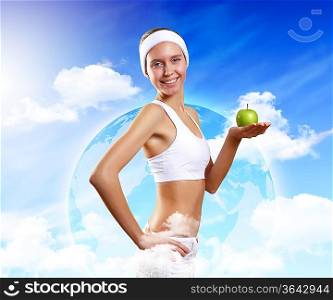 Young pretty girl in sport wear with green apple