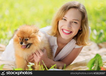 Young pretty girl in summer park with cute dog