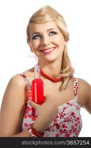 Young pretty girl with color make up hairstyle and color dress drinking from colored bottle some drink, she takes the red bottle with right hand, smile and looks up with dreamy eyes