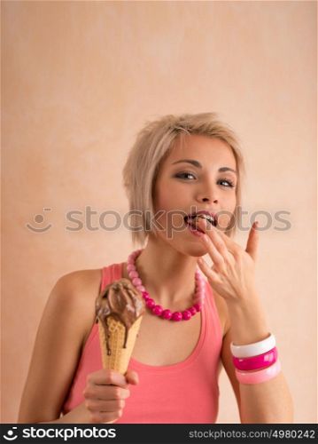 Young pretty girl with short blond hair eating melting chocolate ice cream in cone. 100% satisfaction