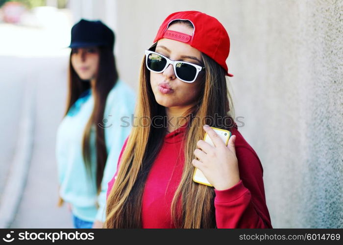 Young pretty girls friends having fun outdoor in autumn sunny evening laughing and going crazy on the street.