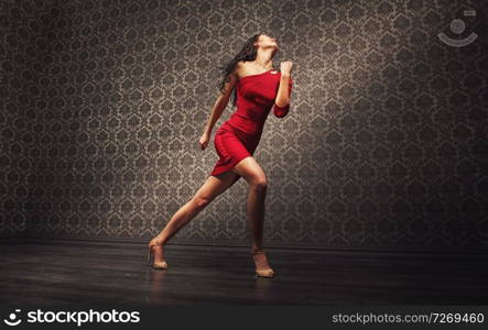 Young, pretty latin dancer practicing alone