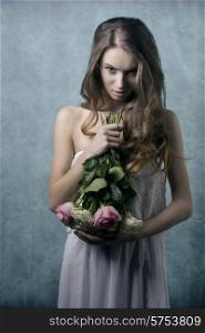Young, pretty, natural, angry girl with flowers and etno dress, with curly hairstyle.