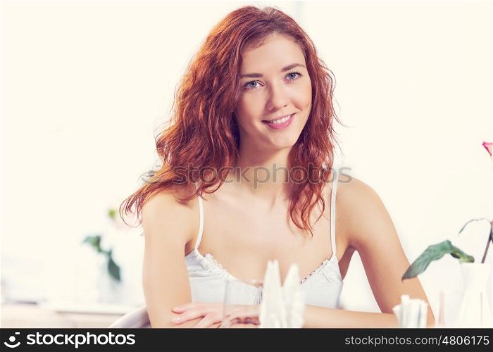 Young pretty red haired woman sitting in cafe. I would like a cup of tea