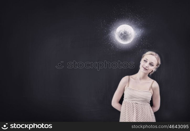 Young pretty smiling woman looking at moon. Back to school