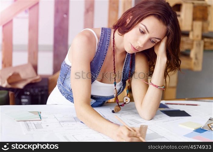 Young pretty woman at her desk. Young pretty woman working at her desk in her office