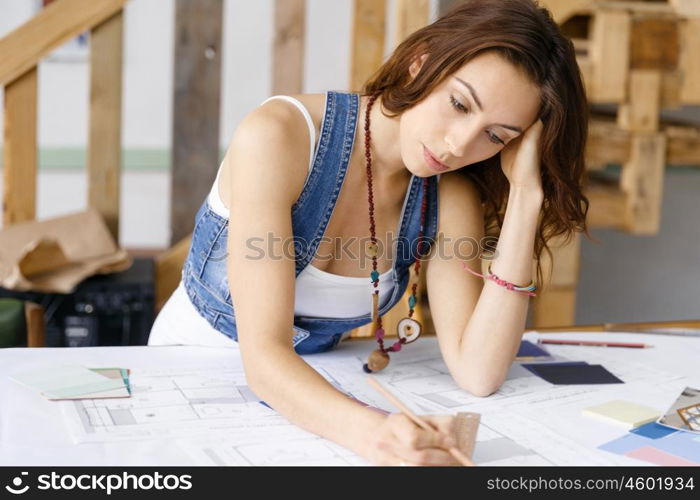 Young pretty woman at her desk. Young pretty woman working at her desk in her office