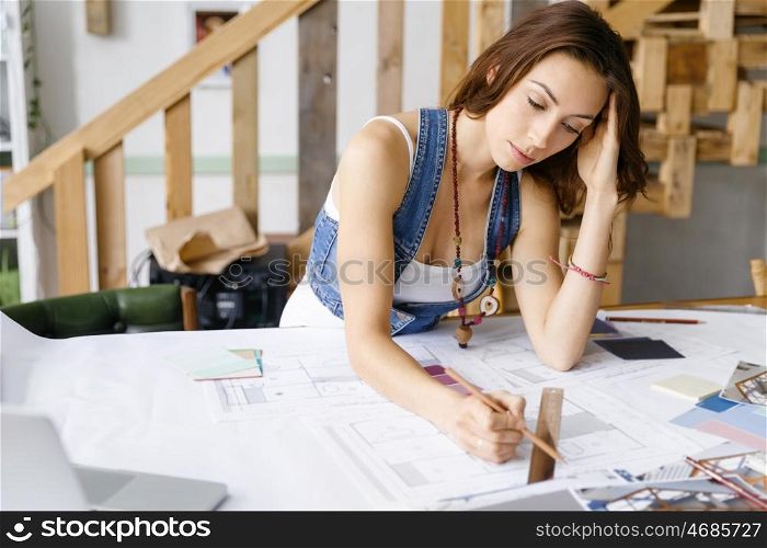Young pretty woman at her desk. Young pretty woman working at her desk in her office