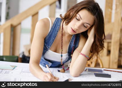 Young pretty woman at her desk. Young pretty woman working at her desk in her office