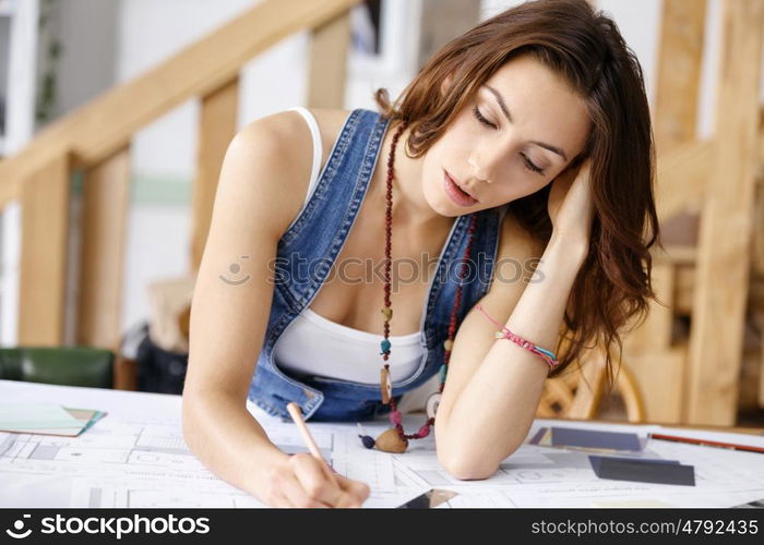 Young pretty woman at her desk. Young pretty woman working at her desk in her office