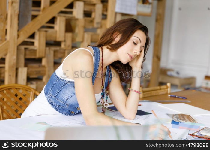 Young pretty woman at her desk. Young pretty woman working at her desk in her office