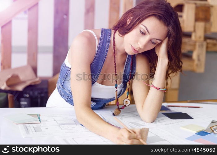 Young pretty woman at her desk. Young pretty woman working at her desk in her office