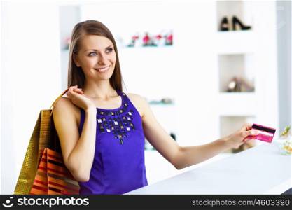 Young pretty woman doing shopping with credit card