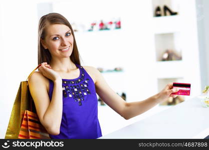 Young pretty woman doing shopping with credit card