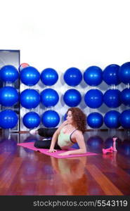 young pretty woman exercising in a fitness center