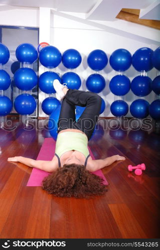 young pretty woman exercising in a fitness center