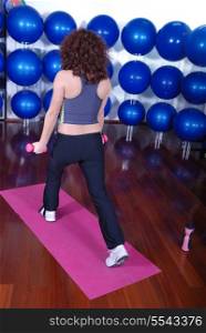 young pretty woman exercising in a fitness center