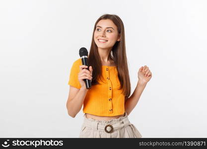 Young pretty woman happy and motivated, singing a song with a microphone, presenting an event or having a party, enjoy the moment.. Young pretty woman happy and motivated, singing a song with a microphone, presenting an event or having a party, enjoy the moment