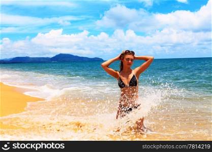 Young pretty woman in bikini and glasses at the beach