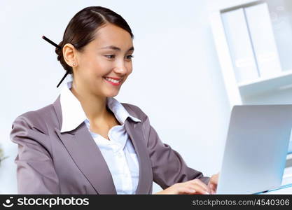 Young pretty woman in business wear working in office